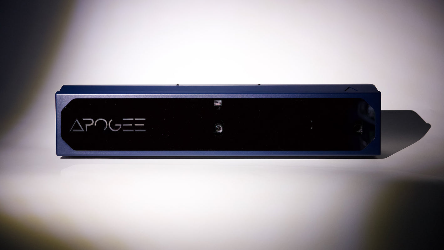 Apogee 3D depth-sensing camera with a sleek blue housing and black front panel displayed against a clean white background.