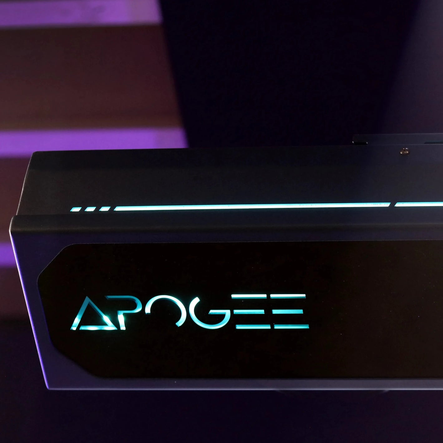Close-up of the illuminated TruGolf Apogee launch monitor, showcasing its sleek design and glowing LED branding.