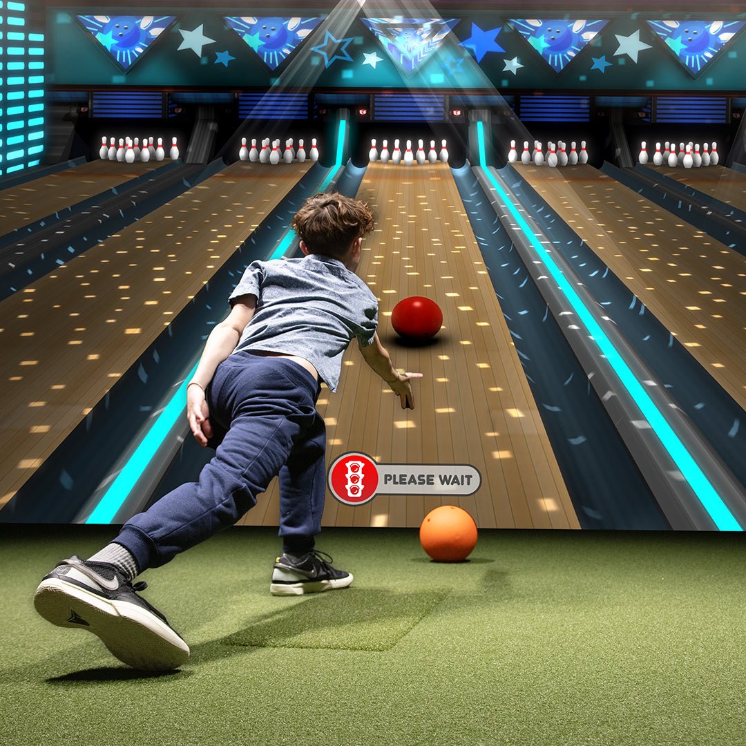 child bowling on indoor bowling simulator with digital lanes and pins