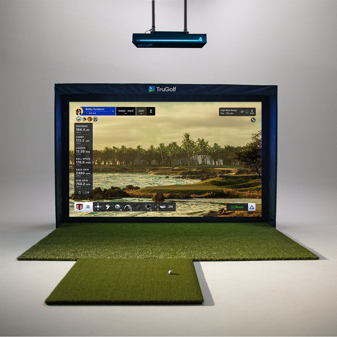 TruGolf golf simulator featuring the Apogee launch monitor, hitting mat, and impact screen displaying a virtual golf course.