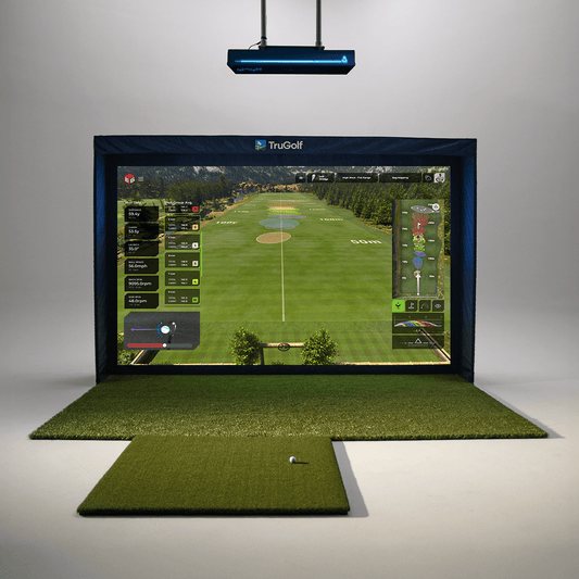 TruGolf golf simulator with the Apogee launch monitor displaying a virtual driving range, complete with hitting mat and ball ready for practice.