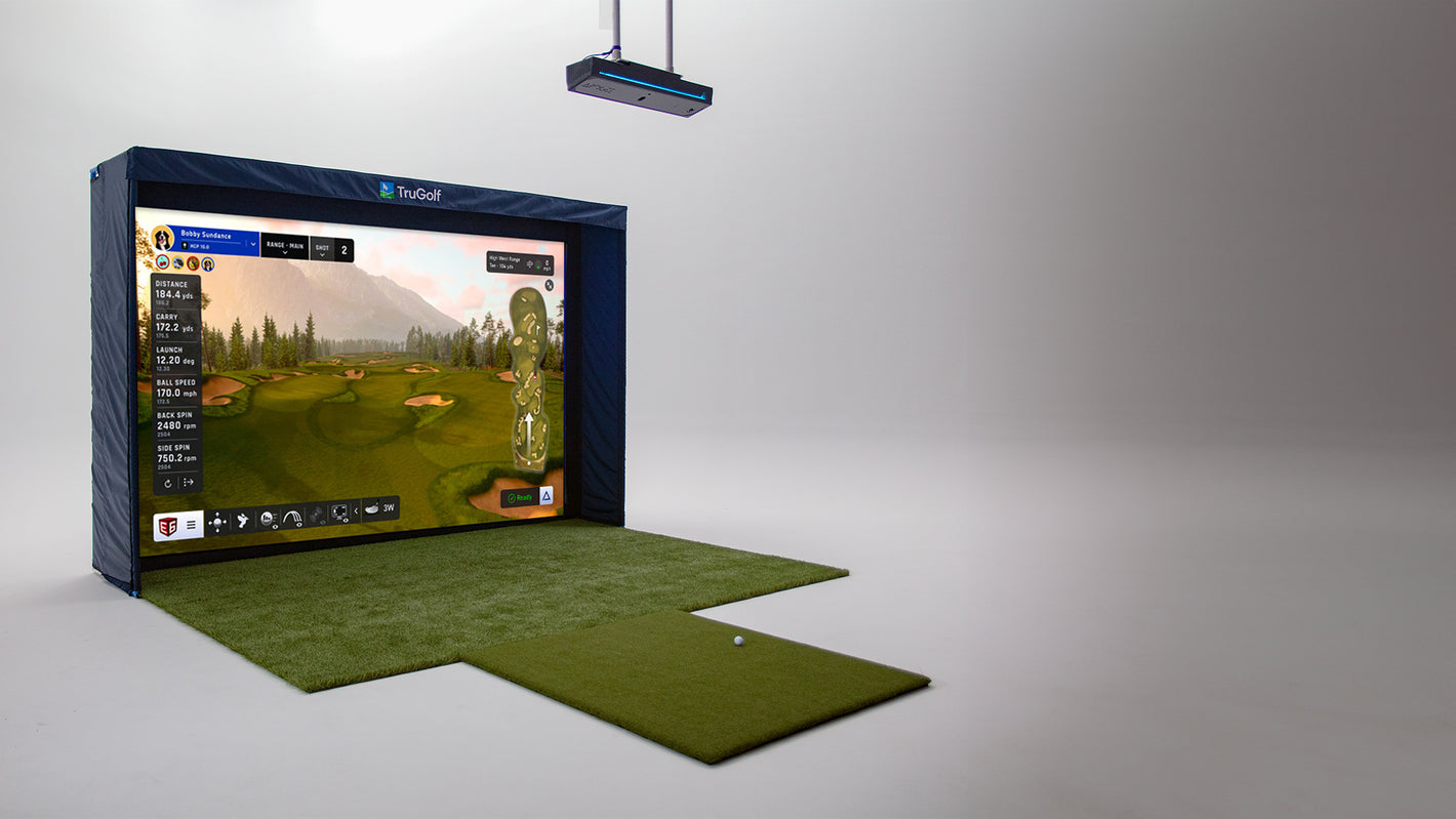TruGolf simulator setup with the Apogee overhead launch monitor, impact screen, and hitting mat displaying a virtual golf course.